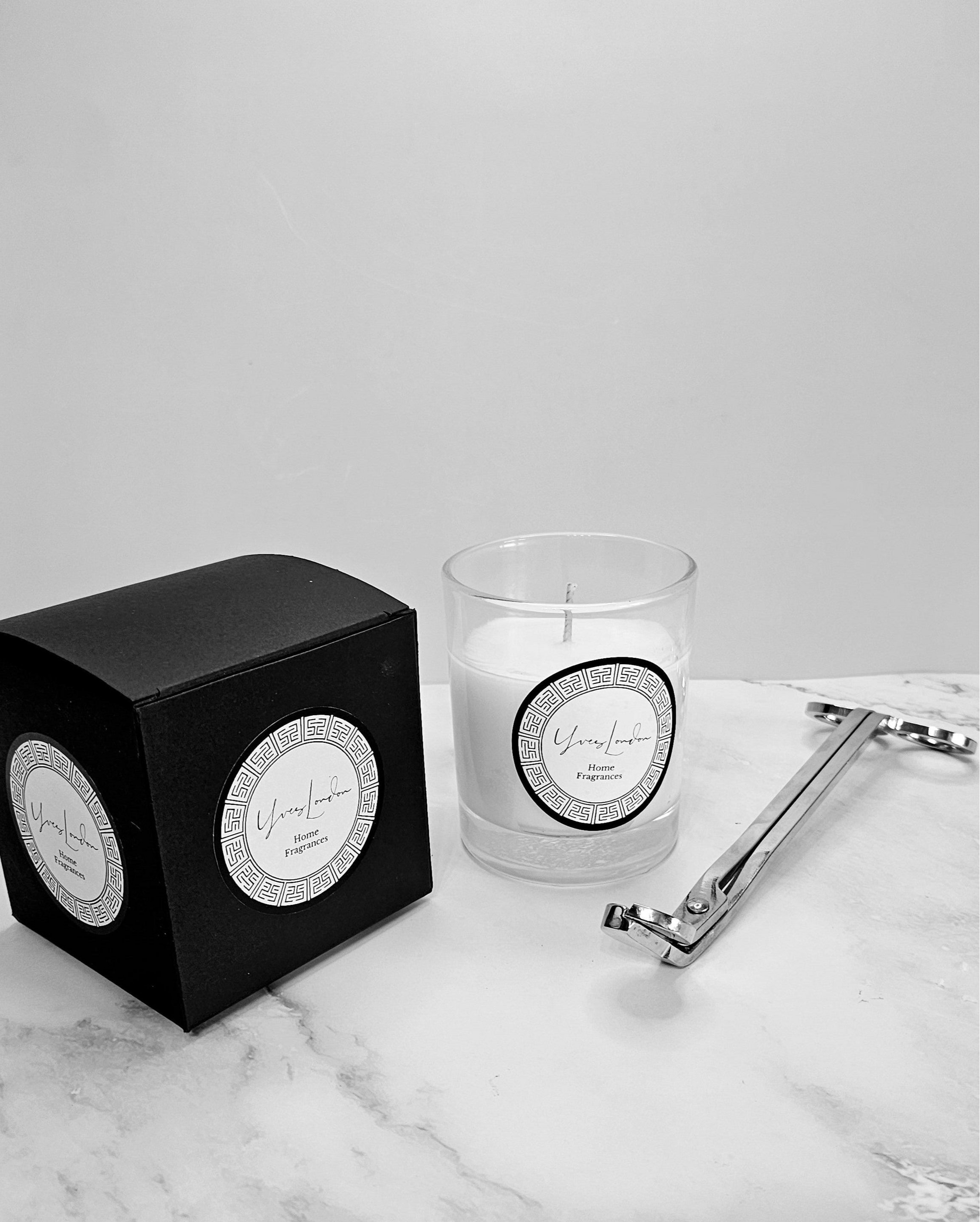 Candle placed on a mantelpiece, complementing a modern living room decor with warm lighting.